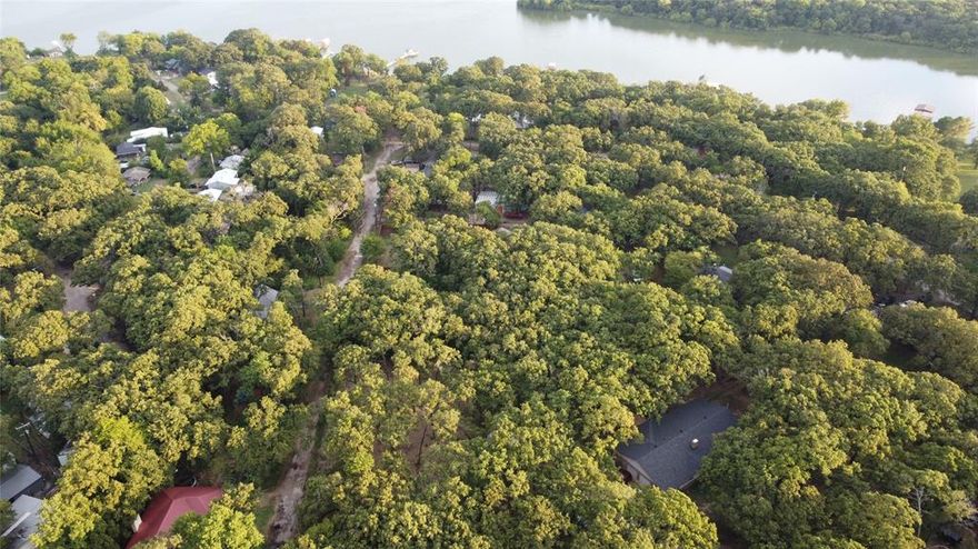 Just off the lake and accessible by a recently repaired road, these contiguous 4 parcels (property IDs: 46116, 46119, 46115, 46120) offer numerous options. Keep them separate or build your dream by the lake on them altogether.  There is already a driveway cut through the center of the property, which connects the roads on either side. The area is heavily wooded. (Please note that the seller will not sell parcels separately.)