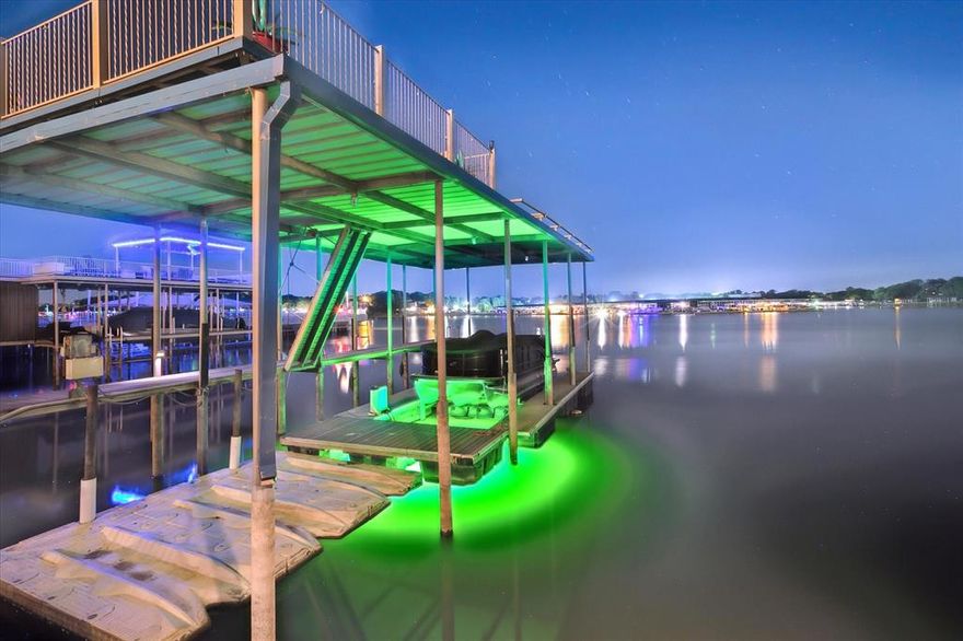 Luxury at Its Finest: One-of-a-Kind Waterfront!
Welcome to an extraordinary lakefront home in the exclusive gated community of Bal Harbour on Eagle Mountain Lake. This custom-designed showplace offers approx. 5,500 sq ft of beautifully curated living space, combining luxurious finishes, unforgettable entertainment features, and panoramic lake views. With 5 spacious bedrooms and 4.5 bathrooms, including a custom bunk room, this home is designed for luxury and comfort. The serene primary suite features breathtaking water views, a custom walk-in closet with a built-in make-up vanity, and a spa-inspired bathroom experience. Relax in the jacuzzi tub or step into the enormous steam shower equipped with multiple wall-mounted body jets, two rainfall heads, and an immersive light and music system—it's like a spa retreat. The incredible indoor-outdoor kitchen and living area features top-of-the-line Viking appliances, karaoke, and a Big Buck Hunt arcade game. This space can be opened up to the outdoors and sealed off from the main house, heated or cooled with its own dedicated HVAC system—a perfect year-round entertaining area. Step outside to enjoy the heated play pool, perfectly positioned to overlook the lake for a spectacular view. Boaters will appreciate the private covered dock with a rooftop deck that can be used for lounging or evening cocktails. There is a lift, LED lighting, plus an additional boat slip in the community marina. Inside, the entertainment continues with a one-of-a-kind custom airplane wing bar featuring 5 beer taps, 5 wine taps, shuffleboard, a poker table, and 3 TVs. Let's not forget about the temperature-controlled wine room, making this the ultimate entertaining experience. The main kitchen is a chef’s dream with a gas F. Bertazzoni range and sleek Italian marble backsplash, Classic elegance meets modern function. Whether entertaining, relaxing, or enjoying life on the water, this rare lakefront gem offers the best of Eagle Mountain Lake living.