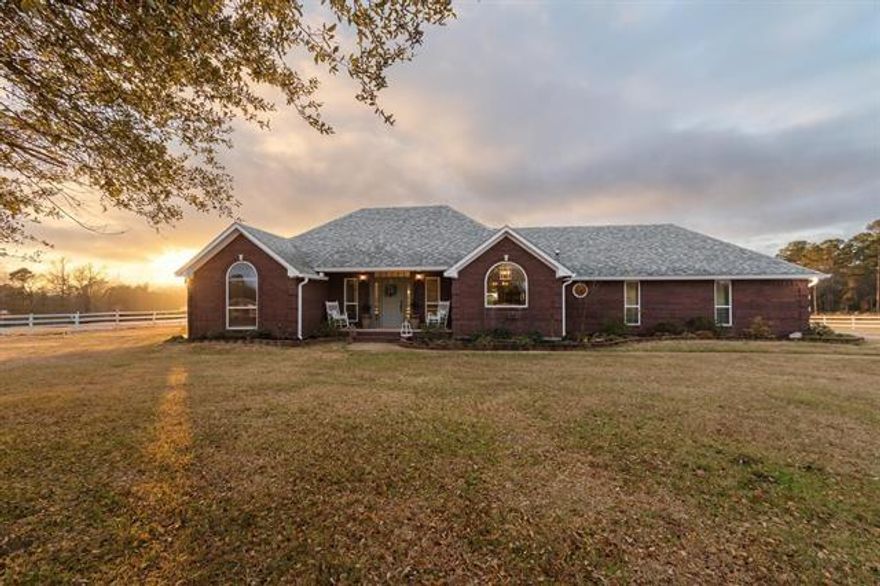 Welcome to your private sanctuary only 10 min from Longview.  This newly remodeled 4 Bd 2.5 bath home blends refined comfort with wide open freedom on 12 rolling acres complete with tight fences, offering the ideal setup for horses, homesteading, or simply savoring peaceful rural living. The thoughtfully designed interior features a dream custom kitchen, anchored by a large picture window over the sink that frames one of the most beautiful views imaginable.  Sunrises and sunsets here are unforgettable-visible for miles from the back covered back porch swing or while gathered around the fire pit.  The gorgeous laundry room, functional mudroom-office and luxury primary bathroom are designed for rest and retreat.  Every space has been beautifully updated, creating a move-in-ready home that feels both elevated and welcoming.  Outside, the land is equally inspiring.  The garden has already been tilled and is ready for planting along with making it easy to begin your homestead vision right away.  A huge barn- freshly updated with a new roof, paint and sliding barn doors-features full-length 15-foot lean-tos, horse stalls, and a tack room, providing everything needed for horses or livestock.   New roof on home 2021 as well as many updates including new custom kitchen cabinetry, new paint inside and out, light fixtures, flooring, updated bathrooms and much more!  The storage building includes electricity, AC-Heat unit and was used for additional living quarters-game room. Enjoy an evening around the fire pit, or collecting fresh eggs from the Hen Hacienda!  BEAUTIFUL COUNTRY SETTING IN A GREAT LOCATION! Make your appointment today to see this East Texas beauty.