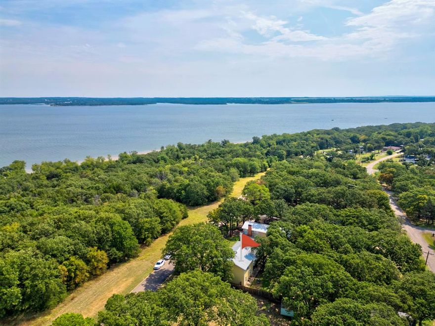 Come to beautiful Lake Texoma ! This lake home is located right across the road from core property , you will never have to worry about development to obstruct your view of Lake Texoma.  Walking distance from the beach and all the nature trails .   Minutes from Megastar and a easy commute to major highways . The home is a split concept with the primary located on the first floor. The oversized bed room on the second level has a separate entrance with a lovely balcony , relax with a beverage and soak in the view .  This home is great for a large family or a income producing VRBO while you enjoy the first level . Book your tour with your favorite Realtor today .