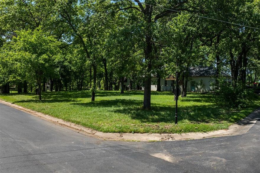 Build Your Dream Home on an Island and Live the Lake Life! Introducing this Oversized, Corner Lot in the Gorgeous Gated Community of Enchanted Isles on Beautiful Cedar Creek Lake. This exceptional interior lot faces the lake with lake views, situated on higher ground. One of the standout features of this property is the breathtaking Lake Views from the front, facing East and looking back towards the causeway. Private community boat ramp.