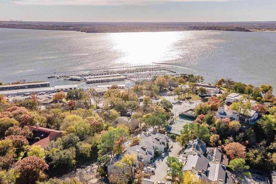 This hidden gem is tucked away on a peaceful peninsula of Eagle Mountain Lake, offering affordable lake life living with incredible views an abundance of natural light. The main living level features a wood-burning fireplace, cathedral-vaulted ceilings, rich wood floors, and a private balcony ideal for enjoying panoramic lake views. The kitchen is thoughtfully designed with a laundry room with extra storage area and a convenient half bath, perfect for entertaining. Downstairs, both bedrooms feature ensuite bathrooms for added privacy. The primary suite offers a walk in closet, a private covered patio with lake views and a full bath, while the second bedroom and bathroom have been completely refinished and are move in ready. The water’s edge is just a short stroll down the hill, making lake access easy and convenient. HOA includes water, sewer, trash and internet. From lock and leave lake living to a weekend getaway or smart investment, this one checks every box. Don’t miss your chance to own a slice of Eagle Mountain Lake without breaking the bank. 1-0 lender paid buydown or lender credit with our preferred lender