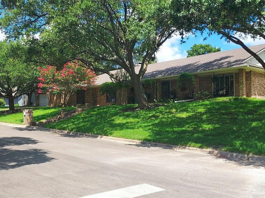 Wonderful 4 bedroom 3 bath home with pool located in the heart of Woodway. Located on a corner lot with many beautiful trees and landscaping. Brand new roof (less than a year old). Large family room with wood-burning fireplace, built-ins, skylights, and wood shutters. Nice kitchen with built-ins, dining area, wood shutters, newer oven and newer dishwasher. Formal dining room. Isolated 4th bedroom with full bath. Large primary bedroom with dual vanities, closets, storage, and newer oversized tile shower. Home has a bonus sunroom! Ths home also has an inground pool wiht beautiful deck. Pool liner is 4 years old estimated. Sprinkler system throughout entire yard.