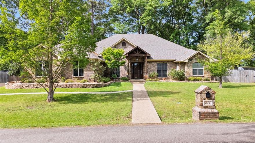 Tucked away on a quiet cul-de-sac in the desirable Bullard, Texas area, this stunning private retreat offers serene water views of Lake Palestine and over an acre of beautifully maintained land. Built in 2010, this thoughtfully designed home features a spacious 4-bedroom split floor plan, 2.5 bathrooms, and an oversized 2-car side-entry garage, blending comfort and functionality with timeless style. Exceptional curb appeal welcomes you with mature landscaping and a peaceful setting. Inside, you’ll find wood-look tile flooring throughout, a recently painted interior in soft neutral tones, and eye-catching trim details that elevate the home’s design. The open-concept layout is ideal for both everyday living and entertaining. The oversized kitchen is truly the heart of the home, offering abundant workspace and room for gathering. Enjoy the benefits of propane upgrades, including a gas stove—perfect for those who love to cook. A formal dining room at the front of the home showcases coffered ceilings and extensive crown molding, creating an elegant space for hosting. The spacious living room is filled with natural light from a wall of windows and features a cozy corner wood-burning fireplace. Just off the living area, the fourth bedroom offers flexibility as a home office or guest space. The primary suite is a true retreat, complete with picturesque backyard views, a generously sized ensuite bathroom, and a large walk-in closet. Step outside to enjoy the expansive covered back porch, fully fenced yard, and thoughtfully designed outdoor features including a storage shed, raised garden beds, blackberry bushes, and an asparagus bed. House features a 22kw full house generator power by buried propane tank and automatic decorative metal gate.  
Surrounded by mature trees, the property offers dappled sunlight and a peaceful, vacation-like atmosphere—perfect for those seeking privacy, beauty, and a connection to nature. **digitally staged photos**