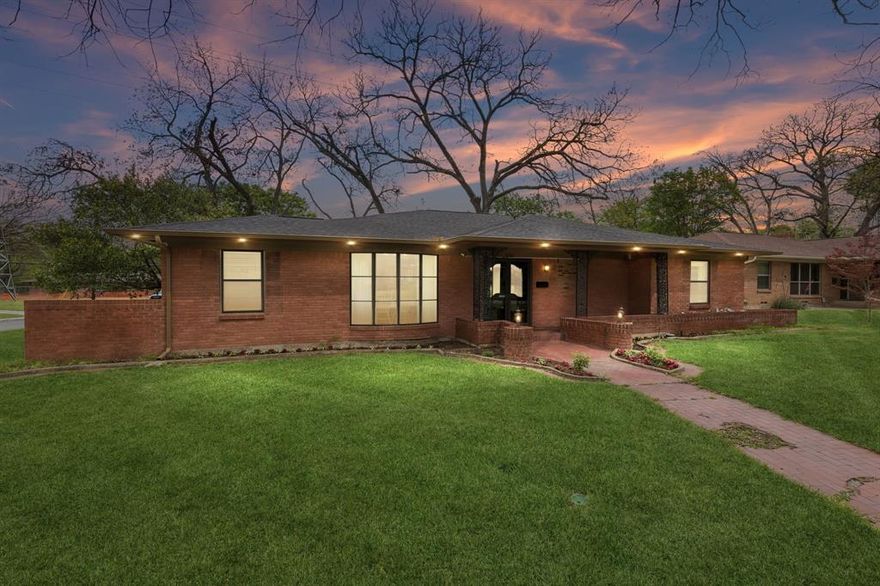 Set on a spacious corner lot, this beautifully remodeled ranch is the perfect blend of modern style and effortless livability. Step inside to crisp white walls, soaring vaulted ceilings, & warm hardwood floors that create a bright, inviting backdrop for everyday living. At the heart of the home, a thoughtfully designed gourmet kitchen steals the show—featuring double ovens, commercial cooktop & range, generous island, walk-in pantry, & sleek pot filler—seamlessly opening to the den for easy entertaining. The living space is both stylish & comfortable, anchored by a contemporary fireplace, expansive art walls, & stunning bank of windows that flood the home with natural light (your plants will love it). Function meets flexibility with a rare, oversized laundry room for a home of this era, plus a dedicated office perfect for working from home or creative pursuits. All of this, just moments from Kiest Park—one of Dallas’s largest and most beloved green spaces, offering 263 acres of trails, playgrounds, sports courts, and a vibrant community recreation center. A home that lives as beautifully as it looks—modern, open, and effortlessly connected to both nature and neighborhood.