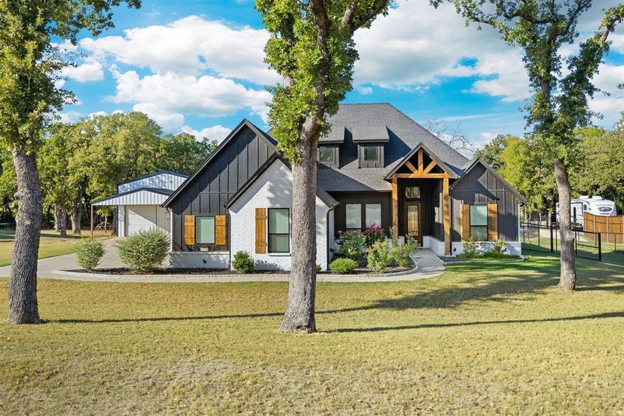 Experience country living at its finest with this stunning 4-bedroom, 2-bathroom home set on spacious acreage with no HOA! The open-concept, split-bedroom layout is centered around a bright and inviting living area featuring a soaring cathedral ceiling and a beautiful black fireplace. Double French doors on either side of the fireplace open to an oversized covered patio overlooking your brand-new heated in-ground pool and spa, both powered by propane — perfect for relaxing or entertaining year-round. The kitchen is a showstopper with sleek waterfall countertops, custom cabinetry, a walk-in pantry, and a double oven. Just off the kitchen, the mudroom conveniently connects the garage to the primary suite, which offers a spa-like bathroom complete with a large walk-in shower, a striking black soaking tub, and a custom closet with built-in cabinetry. The flexible fourth bedroom makes an ideal office or playroom. Outside, you’ll find not only a 3-car garage, but also a 30x40 shop with full electric and climate control, complete with a carport and loft — ready to be finished out for your workshop, guest suite, or hobby area. Enjoy the freedom of acreage, the comfort of modern design, and the peace of mind that comes with no HOA restrictions — all in one incredible property. Property goes past the back fence - please refer to survey for property line.