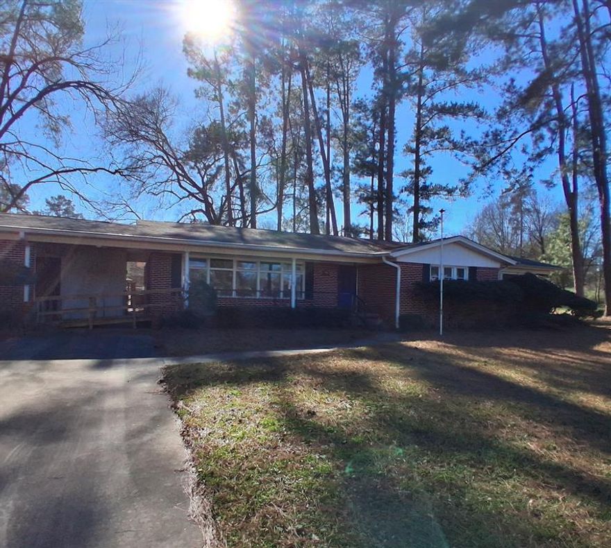 Nice curb appeal! Established neighborhood and great location. This home has 3 large bedrooms and 2 full bathrooms. Features include original hardwood flooring and plenty of large windows. There is a formal dining and formal living room at the front of the house and a family room at the back. The back yard has a nice storage building and plenty of shade trees. There is an attached 2 car carport and small storage area and a handicap ramp at the front of the house. Come check this great home out today before it is gone! Sold AS-IS.