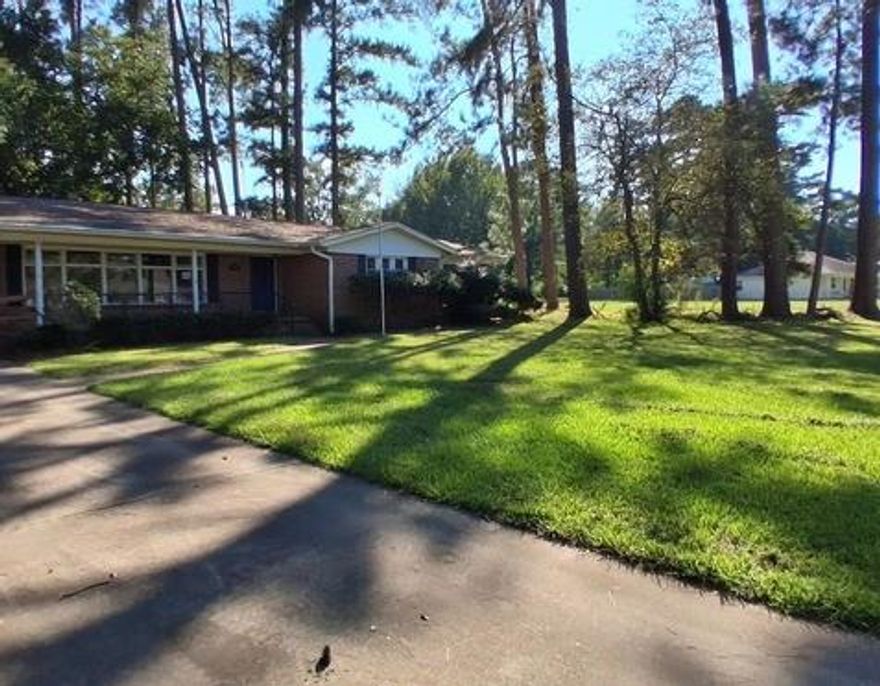 Nice curb appeal! Established neighborhood and great location. This home has 3 large bedrooms and 2 full bathrooms. Features include original hardwood flooring and plenty of large windows. There is a formal dining and formal living room at the front of the house and a family room at the back. The back yard has a nice storage building and plenty of shade trees. There is an attached 2 car carport and small storage area and a handicap ramp at the front of the house. Come check this great home out today before it is gone! Sold AS-IS.