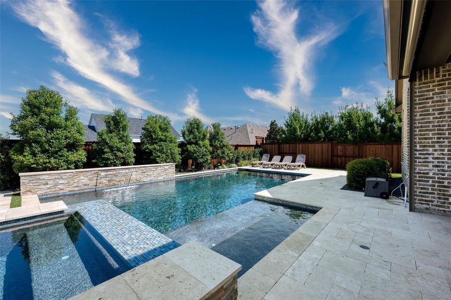 Welcome to this Huntington Home in the Peninsula at Windsong Ranch boasting over 5000 SQFT of luxury with 5 total bedrooms, 5 full and 3 half bathrooms. The moment you arrive you will enjoy the grandeur of the elevation and the brick paved driveway. Step inside the double-door entrance to enjoy your sweeping staircase and grand high ceilings. Engineered wood to all the main living areas on the main floor, executive study with double reeded glass doors, plantation shutters, built in cabinets and shelving, and custom beams. Formal dining room with wood detail accent wall. Family room with beams, stone featured and craftsman fireplace with gas logs. Gourmet kitchen with white painted cabinets, quartz countertops, island, built-in stainless-steel appliances include a Kitchen Aid refrigerator,  6 burner gas cooktop, large butler’s pantry with wine racks and built in wine cooler fridge. Walk in pantry. Breakfast nook. Primary bedroom with seating area, barreled ceiling and wood accent wall. En suite bathroom with separate vanities, quartz counters, garden tub, walk-in shower, walk in custom closet. Guest suite with ensuite and walk in closet. Back stairs with built in benches under stair storage closet. Under-stair storage closet at front stairs of this home. The laundry room has built in cabinets, quartz counters and undermount sink. Upstairs you will find 3 bedrooms all ensuite, walk-in closets. Game room with wood ceiling design and window seating area, full wet bar, built in beverage refrigerator and sink with quartz countertops. Media room with barn door, projector and screen which will remain with sale of home, built in media cabinet for all your equipment storage needs. Power shades throughout the home. Three car garage with epoxy flooring.  Enjoy the backyard with a sparkling pebble tec pool and spa with stone wall water feature. Extended patio with electric screens and TV. Turf and professional landscaping. Firepit area and a putting green. Whole house generator.