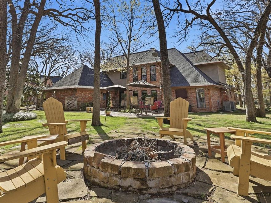 Tucked within the gated community of Corinth Forest, this beautifully maintained 5 bedroom, 3.5 bath home offers a rare blend of charm, comfort, and an enviable setting. The home enjoys a picturesque backdrop that feels both serene and connected. From the moment you arrive, you’re welcomed by timeless brick architecture, mature trees, and a sense of quiet refinement. Inside, the home unfolds with generous living spaces, abundant natural light, and thoughtful details throughout. The main living room is both inviting and elevated, featuring cathedral ceilings and a wood-burning fireplace, designed for gathering as easily as it is for unwinding. At the heart of the home, the fully remodeled galley-style kitchen showcases updated appliances, quartz counters, and a coffee bar, seamlessly opening to a bright breakfast area with direct access to the back patio, perfect for morning coffee or casual meals. For formal occasions, the dining room has large windows all around, filling the space with natural light and creating an airy, elegant setting ideal for intimate dinners and larger gatherings. The primary suite serves as a retreat, with tray ceilings, large windows, a sitting area, and a spa-like bath with a modern walk-in shower and dual vanities. Secondary bedrooms are thoughtfully arranged, with one featuring a private ensuite bath, while two others share a Jack and Jill bathroom, and the largest having the option to be used as a flex space. An office with built-in cabinetry provides a quiet workspace.  The outdoor space is equally inviting, offering an expanded patio and walkway to a firepit, framed by mature trees and a peaceful setting. With the neighborhood fishing pond across the street and the community pool and tennis court within view, the backdrop feels both scenic and connected, perfect for quiet mornings or evenings outdoors. Zoned for Hawk Elementary and just minutes from dining and shopping, this home offers the perfect balance of convenience and seclusion.