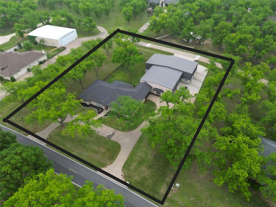Located in the original section of Pecan Plantation Airpark (FAA identifier 0TX1), this well-designed single-story home offers 2,992 sq ft with 3 bedrooms, 3 baths, 2 living areas, 2 dining areas, and a versatile bonus room that could serve as a 4th bedroom. Built in 2002 on 1.46 landscaped acres with several mature pecan trees, the functional floorplan provides generous living and entertaining space, complemented by a large screened patio. Energy-efficient geothermal HVAC adds long-term value. Concrete taxiway access and close proximity to the runway enhance convenience. The impressive 4,000 sq ft hangar features a 68x14 Higher Power door, 18x14 overhead door, and a 28x15 climate-controlled workshop office. Enjoy all the amenities of Pecan Plantation, including 17 miles of Brazos River with three private beaches, a private marina with access to Lake Granbury, golf, clubhouse dining, pools, tennis, parks, shopping, and on-site medical facilities—offering a true fly-in lifestyle within a full-service gated community.