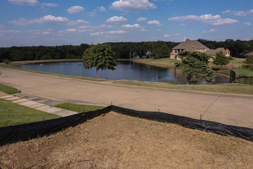 Build your dream home on this 0.77-acre interior lot in the prestigious Lake Ridge at Joe Pool Lake gated community. Nestled across from the pond offering great water views, this cleared and ready-to-build lot features gentle slopes, mature trees, and scenic views. Enjoy community amenities such as walking trails, parks, sports courts, a stocked pond, and nearby Tangle Ridge Golf Club. Conveniently located near Joe Pool Lake, shopping, dining, and major highways, offering easy access to Dallas and Fort Worth.  Enjoy  the peaceful ambiance of a community designed for both luxury and accessibility. The seller’s bank has indicated it may offer financing options, including programs comparable to hard-money financing, subject to credit approval. Reach out to the listing agent for survey and elevation drawings. These documents may also be found on the mls under supplemental documentation.