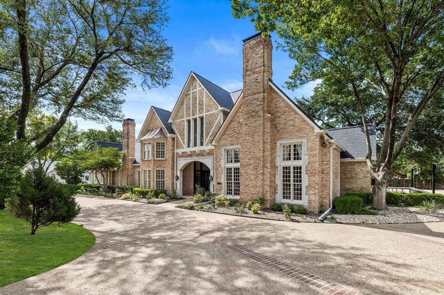 Welcome to this exquisite North Dallas estate nestled on 1.4 acres, the true epitome of luxury and sophisticated living. The first floor showcases an array of refined entertaining spaces, including a wood paneled library, great room flooded with natural light, sun room perfect for hosting a game of cards or mahjong, elegant dining room and family room with a full wet bar. A haven for relaxation and recreation, this property comes complete with a private tennis court that beckons both seasoned players and beginners alike. The sparkling pool and outdoor kitchen provides an idyllic escape during warm summer days. The downstairs primary suite is a spacious retreat with a fireplace, sitting area and spa-like bathroom with two walk-in closets. Three additional ensuite bedrooms down plus two bedrooms suites and an exercise or playroom upstairs provide comfort and privacy for family members or guests. Desirable enclave convenient to shopping, restaurants, major highways and private schools.