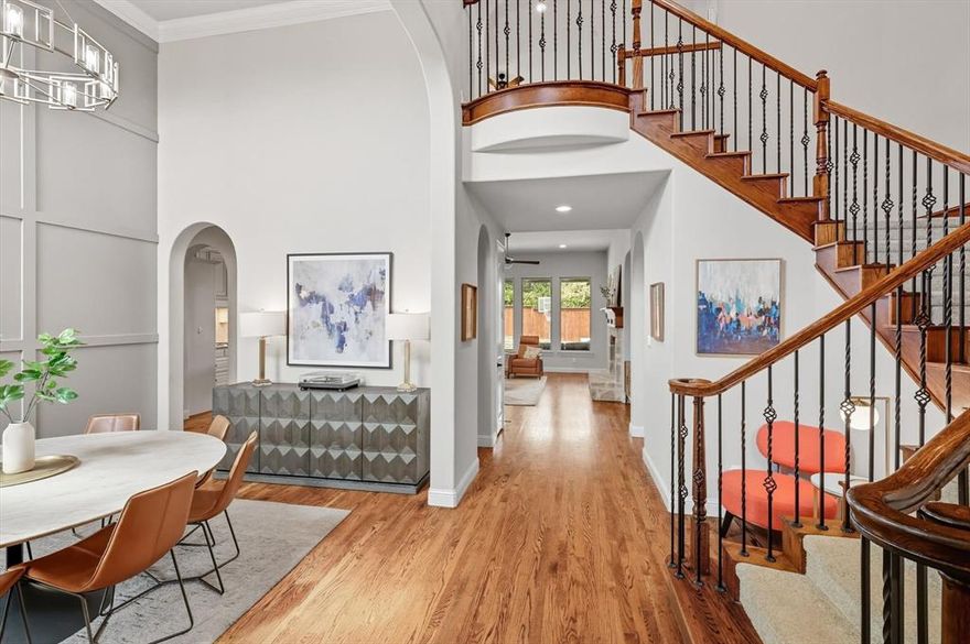 Nestled in the highly sought-after Madison neighborhood of Lantana, 7104 Mitchell Court blends timeless elegance with thoughtful modern updates. Rich hand-scraped hardwood floors flow throughout the main level, where you’re greeted by a versatile formal dining highlighted by an updated feature wall and modern lighting. A private office provides the perfect work-from-home retreat, while the inviting family room with a gas fireplace opens seamlessly to the chef’s kitchen—complete with white cabinetry, granite countertops, a farmhouse sink, gas cooktop, and newer dishwasher. A spacious breakfast area and a wall of windows fill the home with natural light. The primary suite offers a cozy sitting area and a spa like master bathroom and updated closet.   While a second bedroom with an ensuite bath on the first floor is ideal for guests or multigenerational living. Upstairs, you’ll find a media room wired for surround sound (with four speakers included), a game room, and three additional bedrooms—one with a private ensuite and two sharing a dual-sink bath. Outdoor living is a true highlight with a travertine patio, built-in grill, and a private backyard that backs to a lush greenbelt—perfect for both entertaining and unwinding. Additional upgrades include a 3-car garage with Gorilla shelving, new 2025 roof and gutters, fresh interior and exterior paint, updated light fixtures and fans. A laundry room with custom mud bench and cubbies, abundant storage, and three new toilets add everyday convenience. Lantana residents enjoy award-winning amenities such as walking trails, community pools, tennis and pickleball courts, and top-rated schools. With its modern touches and move-in ready updates, 7104 Mitchell Court is the perfect place to call home.