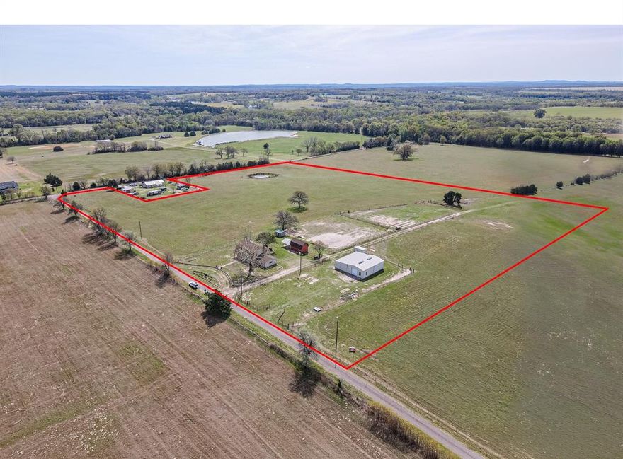 Located in the peaceful countryside between Ben Wheeler and Martins Mill, this exceptional property offers approximately 20 acres of scenic East Texas land paired with a distinctive two-story log home and valuable improvements.

The 2,836 sq ft Satterwhite log home showcases engineered log construction crafted from 100-year-old California Engelmann Spruce, harvested from high-elevation Rocky Mountain forests. This specialized construction is designed for long-term durability, structural strength, and improved energy efficiency, offering the beauty of a log home with enhanced performance and longevity compared to traditional log construction.

Inside, the home features an expansive layout with generously sized rooms, creating a comfortable and inviting space ideal for everyday living and entertaining. A charming summer kitchen adds to the appeal, perfect for hosting gatherings or enjoying quiet Texas evenings.

The land offers sandy loam soil, well-suited for livestock, agricultural use, or recreational enjoyment. Additional improvements include a barn and shop with covered equipment area, providing ample space for tractors, tools, and workspace needs. A private pond enhances both the beauty and functionality of the property.

Serviced by private well water, this property offers the independence and rural lifestyle many buyers are seeking, all while being surrounded by open pasture and picturesque countryside views.

Additional acreage may be negotiable, providing flexibility for buyers desiring expanded land opportunities.