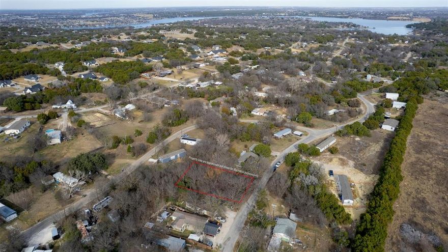 This lot presents a fantastic opportunity to build your next home in the gated Indian Harbor Lakefront Community in Granbury, TX. Residents enjoy access to a private marina with boat launching and covered slips, a clubhouse with a swimming pool, and an activity center. Nestled among rolling hills and mature trees along the shores of Lake Granbury, this property offers the peace and quiet of country living while remaining just 10 minutes from Granbury’s historic downtown square.
