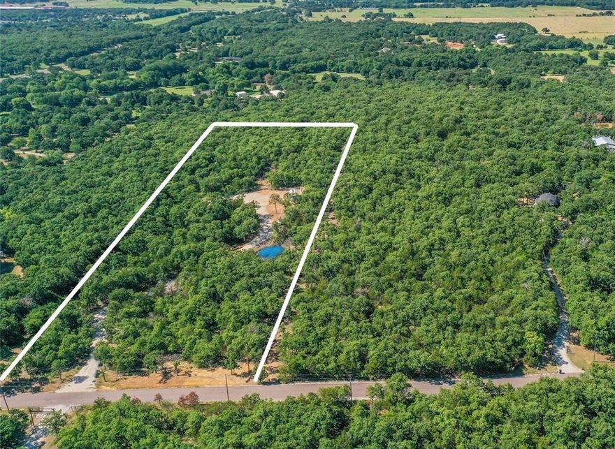 5 acres of GORGEOUS heavily treed land just minutes from Lake Ray Roberts! Enter the property on a pristine winding drive leading to a secluded build site that is prepped and ready for a dream home. Property is ready to go with tons of dirt work completed, including multiple culverts, a deep pond, and all drainage needed for construction. Underground electric buried all the way to the home-site with transformer in place. Mountain Springs Water at road. Massive 100 foot long 4 foot tall reinforced concrete retaining wall wraps the back of the site with stairs giving access to the back side of the site. Truly a scenic and private view from every angle on this beautiful property.