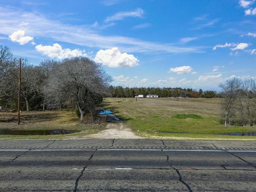 Prime development opportunity on State Highway 31 in Navarro County. This 65.352-acre tract has just received a major price improvement, making it one of the most compelling large-acreage options available along the rapidly growing HWY 31 corridor.

With 225 feet of direct highway frontage, the property offers excellent visibility, easy access, and multiple development paths—residential, commercial, industrial, agricultural, or mixed-use. Improvements include two homes (built around 2013), a 20×30 workshop, three stock tanks (including one approximately 35 feet deep from a TXDOT excavation), and a mix of open pasture, trees, and gently rolling elevation.

Additional highlights include:
• Outside city limits
• Co-op electricity and rural water district service available
• Agricultural exemption in place
• Ideal for investors, developers, or those seeking a private estate
• Strong growth trends between Corsicana and Kerens