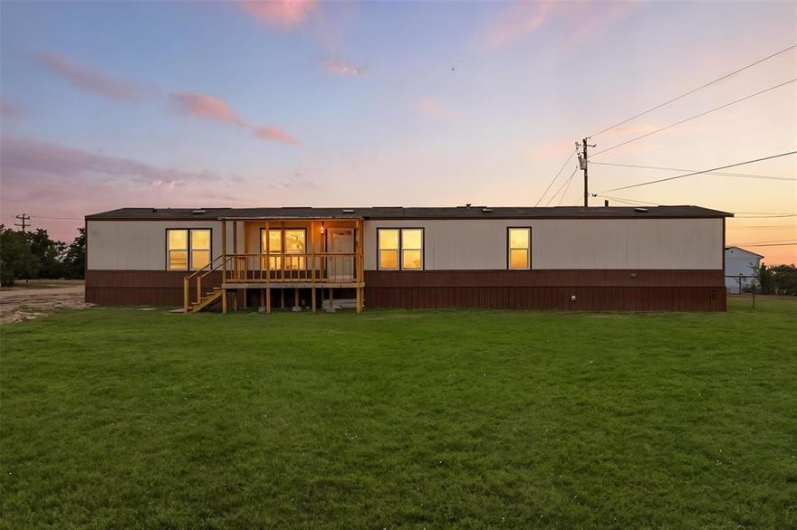 Recently updated single wide manufactured home located on 2 large lots totaling a quarter acre. 2017 model 16X80 Clayton manufactured home featuring 3 full bedrooms, 2 full baths, and 1280 square feet. This home and property has it all and is priced to sell! Inside you will find elegant wood look flooring and new carpet. High ceilings with elegant wood beams and stylish earth tone colors. Large and open living room features built in cabinets, ceiling fan, stylish flooring, and window coverings. Open and roomy kitchen with large island, ample cabinets, and full electric appliances. Stove, dishwasher, refrigerator, and microwave. Large and separate utility room includes washer and dryer. Separate large primary bedroom features ensuite bath, large walk in closet, and ceiling fan. Primary bathroom features double sinks and a custom installed beautiful oversized walk in shower. Opposite side of the home features bedrooms 2 and 3. Each bedroom is roomy with ceiling fans and sizable closets. Bathroom 2 also features 2 sinks and a tub shower combo. Outside this home has a lot to offer. Situated on 2 large lots on a quarter acre, you will enjoy a newer septic system, fenced backyard, and an awesome 15' long X 8' wide covered front deck that is perfect for sitting and relaxing while also protecting you from the elements. Open back deck also on the back door for easy access to the backyard. Gravel driveway, storage building in the back yard to hold the lawn equipment, and a very nice large fenced backyard. Coop electric and water offer low cost utilities. This home is conveniently located just off Tin Top Highway with quick access to Granbury and Weatherford.