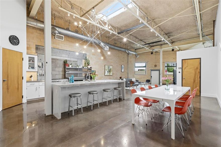 Step inside this architect-renovated home where industrial loft character meets modern comfort. The open-concept layout feels both expansive and effortless, with soaring ceilings, soft natural light, and oversized walls perfect for showcasing art—or finally starting your collection. The kitchen is a true centerpiece, designed for both everyday living and entertaining. Featuring a Thermador range, stainless-steel countertops, and a striking waterfall island, it’s a space that balances style and function beautifully—whether you’re hosting friends or enjoying a quiet night in. The oversized primary suite offers a private retreat with spa-like appeal. Unwind in the large walk-in shower or the classic clawfoot tub, and enjoy the rare bonus of generous storage tucked above the primary bath—an uncommon perk in loft-style living. Throughout the home, thoughtful design details, clean lines, and a highly functional layout create a space that adapts seamlessly to entertaining, working from home, or simply relaxing. Opportunities like this are rare in Deep Ellum—especially a single-family attached loft with no HOA that combines distinctive design, spacious living, and exceptional walkability. If you’re looking for a home with personality, style, and an unbeatable location, this is it.