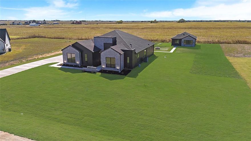 Modern living meets multi-generational flexibility. Nestled in a private cul-de-sac within the sought-after Carrera Ranch Subdivision, this Waxahachie gem offers the best of contemporary design and functional versatility just minutes from downtown, shopping, and dining. The main residence spans 2,574 sq ft, featuring 4 bedrooms and 3 baths with an open-concept layout perfect for entertaining. Thoughtfully designed with high ceilings, sleek fixtures, and abundant natural light, every detail exudes modern sophistication. The chef’s kitchen flows seamlessly into the spacious living and dining areas, ideal for gatherings. Additional highlights include an oversized 2-car garage, full-home water filter and softener system, and foam-capped insulation throughout including the garage for exceptional energy efficiency and comfort year-round. A separate ADU or Mother-in-Law Suite adds 774 sq ft of independent living space with 2 bedrooms and 1 bath, its own electric meter, 911 address (2974), water filter system, and full foam insulation with sound-barrier construction. Whether used for guests, extended family, or rental income, this suite delivers privacy without compromise. Set on a 1.037-acre lot, this property offers ample space for outdoor living, entertaining, or future pool addition all while maintaining an easy commute to city conveniences.