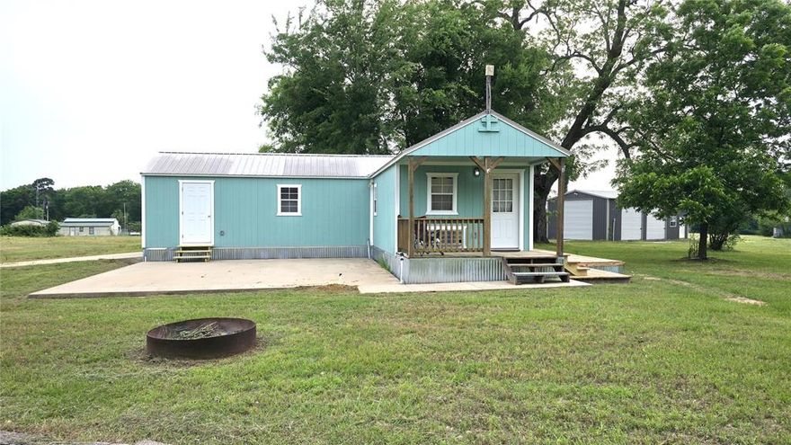 Welcome to 1055 County Road 1226 in Quitman—your retreat at Lake Fork on 5.22 acres. Enter through a private electric gate off CR 1226 or through Holiday Village’s secured entrance. This property features a newly remodeled 2-bedroom, 1-bathroom cabin offering 878 sq. ft. of cozy living space. Inside, you’ll find a full-size kitchen with stainless steel appliances, pecan shelves, a bathroom with a walk-in shower and double vanity, plus a full-size washer and dryer. The cabin is sitting on majority concrete blocks and has been tied down to concrete piers. A concrete patio is ready for your outdoor kitchen plans, while evenings are best enjoyed on the side wood deck beneath a sprawling pecan tree.  A highlight of the property is the 20' x 44' (880 sq. ft.) metal workshop on a concrete slab, complete with electricity and three roll-up doors—perfect for storing your boat, ATVs, or setting up a hobby shop. Two RV hookups and three electric meters add flexibility and potential rental income.  The land offers open space, wildflowers in spring, and plenty of room to grow. Holiday Village amenities include gated security, boat ramps, fishing piers, swimming pool, clubhouse, and playgrounds.  This property is ideally located—just 5 minutes to a 6-lane public boat ramp where Bassmaster Elite tournaments are hosted, and 5 minutes to SRA Swearingen Park with playgrounds, splash pad, piers, and pavilions. Enjoy small-town charm in Quitman (5 minutes), live music at Neon Moon (10 minutes), or head 30 minutes to Sulphur Springs for shopping at Walmart and Lowe’s. Canton’s famous First Mondays are a short-day trip away. Whether you’re seeking a weekend getaway, rental opportunity, or full-time retreat, this Lake Fork property delivers space, convenience, and lifestyle.