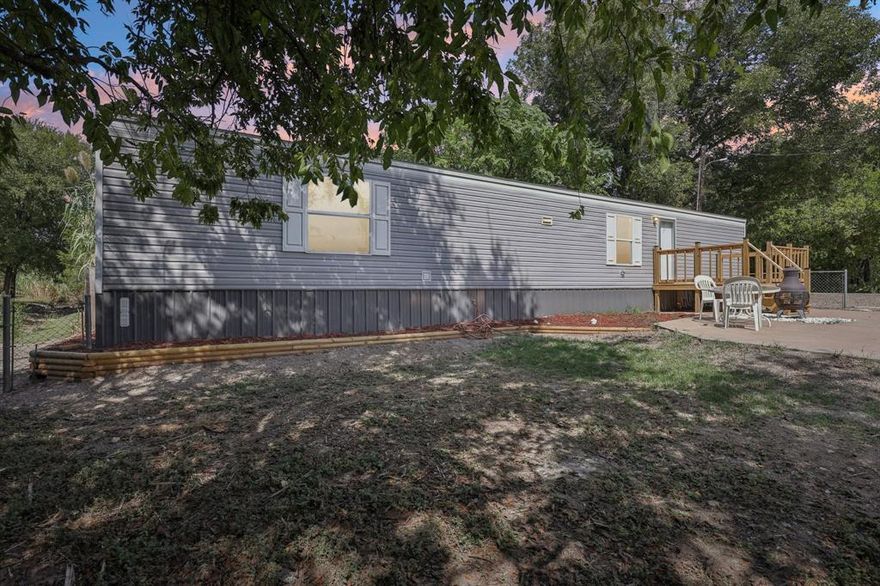 Welcome home to this like brand new 2022 Clayton 14WX60L, 2 bedroom, 2 bath, 840 square feet single wide manufactured home located in the gated Lake Granbury community of Indian Harbor! This home and property shows pride of ownership throughout. Newer HVAC recently installed! Inside you will find wood look laminate flooring throughout, large open living room, open kitchen complete with black appliances. Refrigerator, stove, dishwasher. Separate utility room just off the kitchen with full washer and dryer connections. Breakfast area just off the kitchen with window views. Roomy master bedroom with ensuite bath and walk in closet. 2nd bedroom located at opposite end of the house for the ultimate in privacy. 2nd bedroom features a walk in closet and its own private bathroom. Exterior of home features a seasonal creek in the back of the property and an extra large front deck with plenty of room for grilling, sitting, and relaxing! Vinyl siding and a shingle roof. Large front patio area with views and privacy. Chain link fence and wood privacy fencing will give you a secure and private yard. Indian Harbor is a beautiful gated and guarded Lake Granbury community that features 24 hour security. Enjoy Lake Granbury access from a community boat ramp, community marina, community marina restaurant, community pool, walking trails, clubhouse, community library, and a community fire department. You get all these amenities with a very low cost HOA. Community is centrally located just minutes from Glen Rose and minutes from the Historic Granbury Square. Coop Electric, high speed internet, cable TV, and more all available. This cozy and cute mobile home is priced to sell and makes a perfect home for a first time homebuyer, investor, or someone looking to downsize.