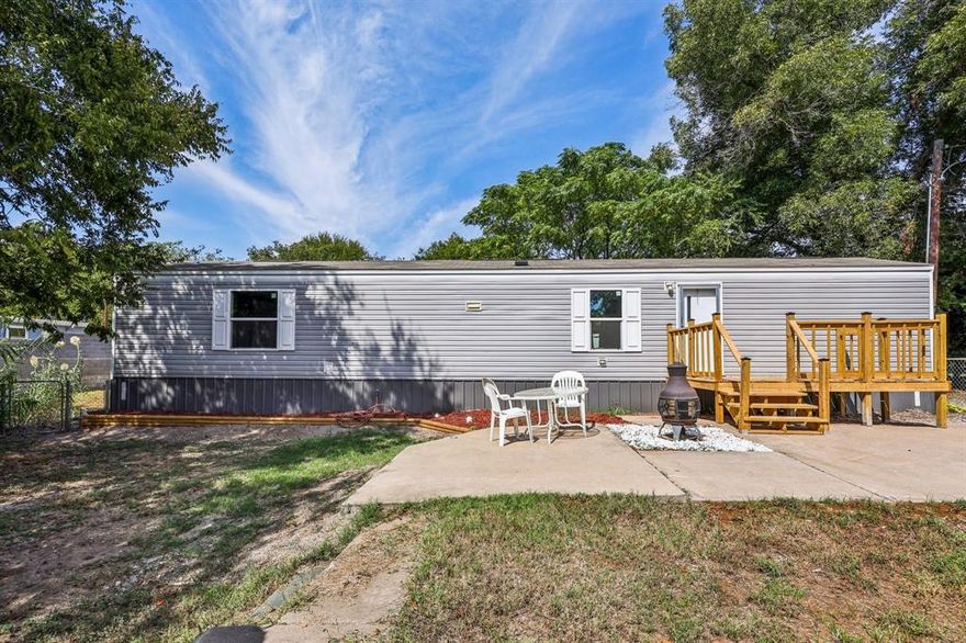 Welcome home to this like brand new 2022 Clayton 14WX60L, 2 bedroom, 2 bath, 840 square feet single wide manufactured home located in the gated Lake Granbury community of Indian Harbor! This home and property shows pride of ownership throughout. Newer HVAC recently installed! Inside you will find wood look laminate flooring throughout, large open living room, open kitchen complete with black appliances. Refrigerator, stove, dishwasher. Separate utility room just off the kitchen with full washer and dryer connections. Breakfast area just off the kitchen with window views. Roomy master bedroom with ensuite bath and walk in closet. 2nd bedroom located at opposite end of the house for the ultimate in privacy. 2nd bedroom features a walk in closet and its own private bathroom. Exterior of home features a seasonal creek in the back of the property and an extra large front deck with plenty of room for grilling, sitting, and relaxing! Vinyl siding and a shingle roof. Large front patio area with views and privacy. Chain link fence and wood privacy fencing will give you a secure and private yard. Indian Harbor is a beautiful gated and guarded Lake Granbury community that features 24 hour security. Enjoy Lake Granbury access from a community boat ramp, community marina, community marina restaurant, community pool, walking trails, clubhouse, community library, and a community fire department. You get all these amenities with a very low cost HOA. Community is centrally located just minutes from Glen Rose and minutes from the Historic Granbury Square. Coop Electric, high speed internet, cable TV, and more all available. This cozy and cute mobile home is priced to sell and makes a perfect home for a first time homebuyer, investor, or someone looking to downsize.