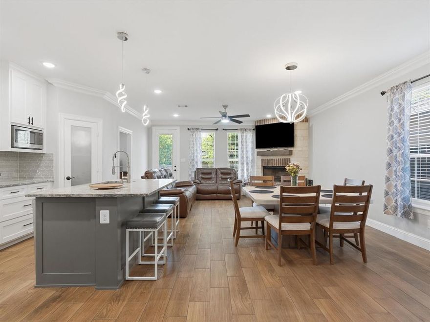 Space like this is getting harder to find, especially for buyers relocating or planning for multigenerational living, and 2316 Stalcup Rd delivers in a way that feels both practical and thoughtfully designed. With 6 bedrooms and 2.5 bathrooms, the layout allows everyone to have their own space while still offering areas to come together, whether it’s around the wood-burning fireplace or in the main living areas finished with durable wood plank ceramic tile. Upstairs, LVP flooring continues the clean, low-maintenance feel, and the extended patio adds another layer of usable space that works well for morning coffee, evening wind-downs, or accommodating a full household. Throughout the home, details like crown molding, custom cabinetry, a glass front door, updated lighting and ceiling fans, and a Gray Glacier linear glass mosaic backsplash add personality without overwhelming the space, while polished porcelain tile bathrooms keep everything feeling fresh and refined. Outside, the extended concrete driveway makes day-to-day parking easier for multiple vehicles, and the 8-foot stained fence creates privacy you can actually enjoy, whether you're hosting or just relaxing. The separate workshop with electricity is a major bonus for anyone who needs a dedicated space for projects, storage, or even a small business setup. The stone and brick exterior, arched brick entry, and stone walkway give the home a strong presence from the street and a sense of durability that holds up over time. Positioned in East Fort Worth, you’re minutes from I-820 and I-30, making commutes into downtown Fort Worth or Arlington straightforward, and close to everyday conveniences like grocery stores, dining, and retail along Meadowbrook Drive and Eastchase. This is the kind of home that adapts to real life, whether that means accommodating extended family, working from home, or simply having room to grow. Schedule a showing to see how it fits what you need next.