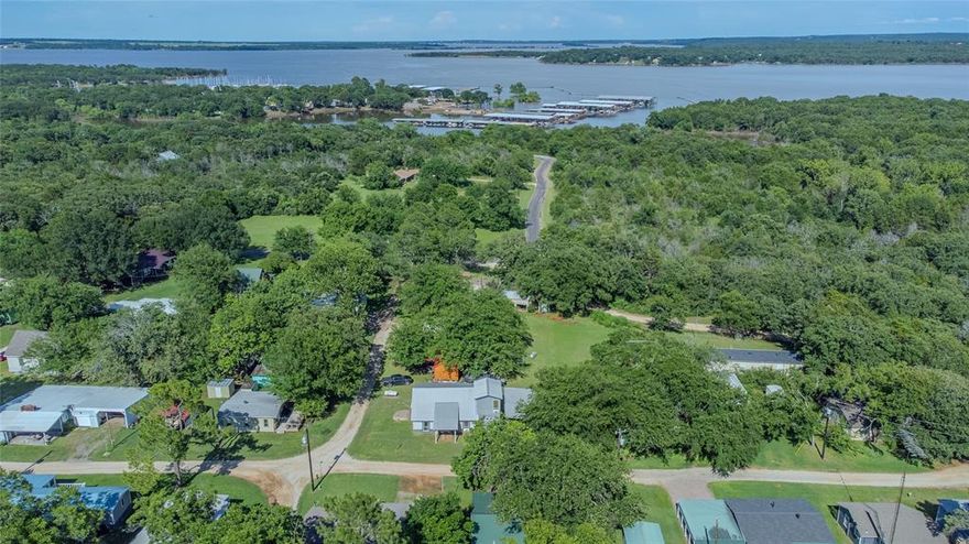 Welcome to lake life!  Are you ready to escape the daily grind and soak in the serenity of being at the lake? This 4 BR 2 BA home has plenty of room for the family and friends.  Two bedrooms upstairs and 2 bedrooms downstairs along with 2 living areas make it a great place for entertaining or just relaxing and enjoying the simple life at the lake. Large windows and beautifully crafted woodwork give the home a very peaceful feeling. Being so close to the lake makes it easy to enjoy activities like boating, fishing and swimming.  The outdoor patio is perfect for evenings around the fire pit or just to sit in a chair and enjoy the wildlife. Another added bonus is a covered parking spot for the RV and a shop for all of your lake toys  This home is located in a quiet neighborhood less than a mile from the water along with Pelican’s Landing Restaurant and Cedar Mills Marina. It is only about a 10 min drive to the Megastar Casino.  This home is in the final stage of a remodel and being sold as is. Vacation Rentals are not permitted. This property is a lease hold. No full time residence.