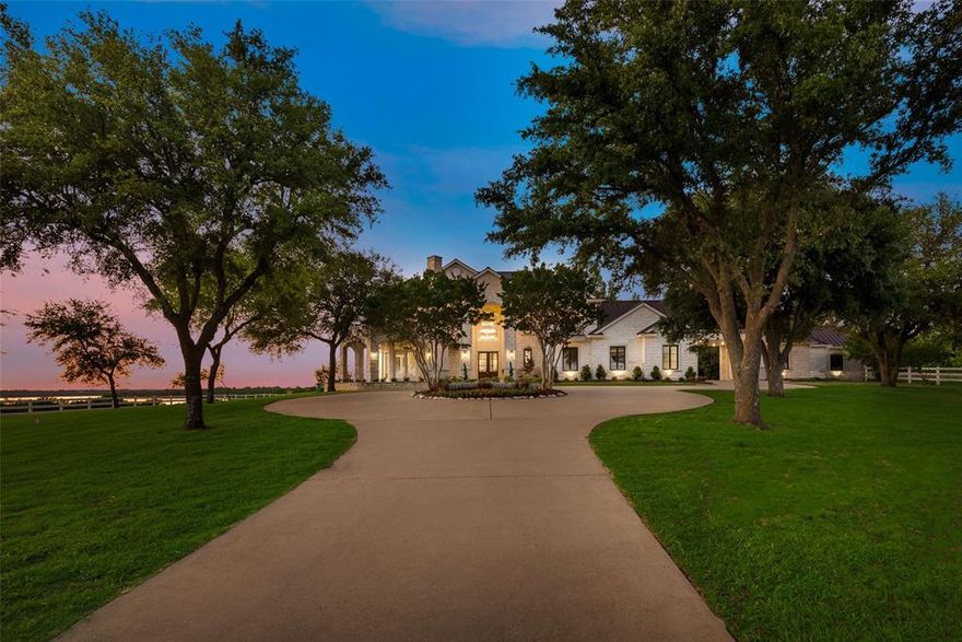 Gated Estate situated on approximately 24 acres with stunning lake views. This home with stone elevation has been newly renovated utilizing the expertise of a professional designer. Custom kitchen with waterfall granite island, Sub Zero refrigerator, stainless gas stove and appliances plus a Butlers pantry-prep kitchen for extra storage. Cozy Morning Room with fireplace, dining room and rotunda living room provide walls of glass that leads out onto wrap around Veranda offering sweeping lake views and evening sunsets! Master suite has sitting area with fireplace, oversized closet with island and spacious private screened patio for relaxing and taking in the serene gardens, countryside and Lake-views. Gorgeous Pool area offers an abundance of entertainment spaces with outdoor kitchen, spa, and covered sitting area. Additional amenities include 1946 sq ft of bonus living areas, large pond, cross fenced, horse barn with storage, stalls and electricity. Come see this Breathtaking property