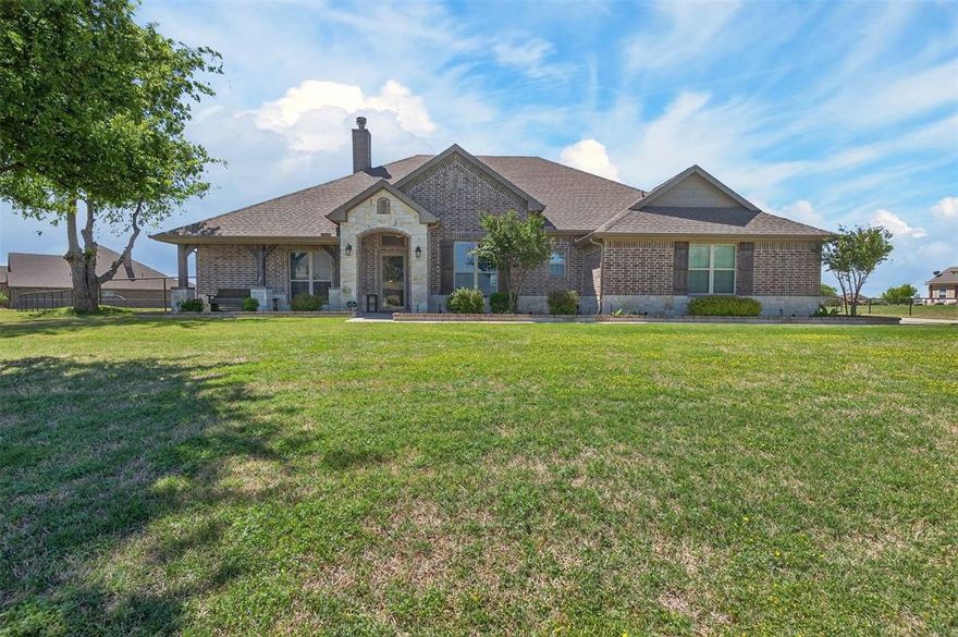One owner - Riverside home featuring a grand entry that opens to a formal dining room on the right and a private office with French doors on the left. The spacious living area offers abundant natural light with windows overlooking the backyard.
The chef’s kitchen is well-appointed with granite countertops, decorative backsplash, stainless steel appliances, and a large walk-in pantry. A convenient mudroom is located between the kitchen and garage.
Secondary bedrooms are generously sized and thoughtfully separated from the primary suite. The primary retreat showcases designer paint colors and leads to a luxurious en-suite bath with dual sinks and vanities, an oversized shower, and a garden tub.
This home is outside city limits and boasts excellent curb appeal with enhanced exterior lighting and upgraded masonry around the flower beds. The extended concrete driveway leads to secondary storage shed with covered porch for added functionality and charm.