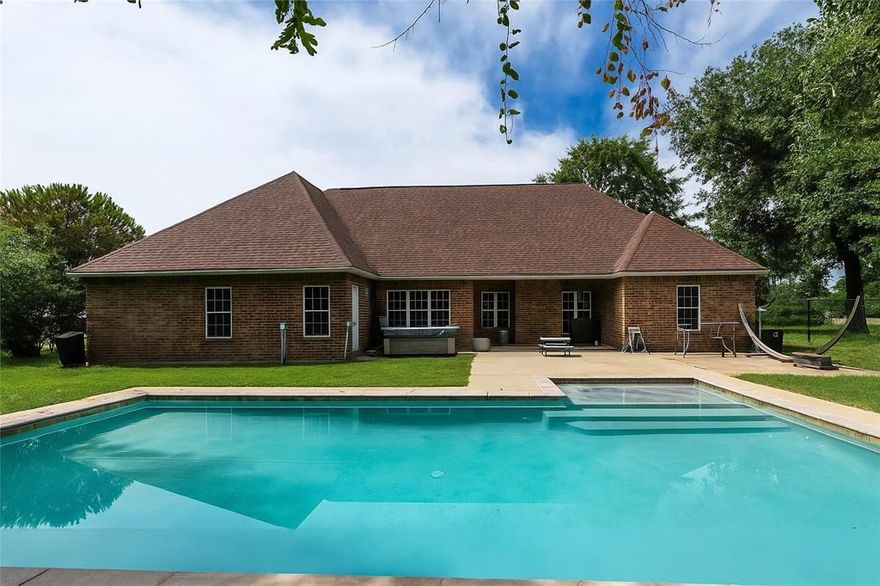 This spacious home is in the gated neighborhood of Spanish Shores nestled along the shoreline of Cedar Creek Lake. The home sells on one lot, with a second lot adjoining also available. You will love the salt water pool in back with cool decking added in 2017, perfect for hosting all of the parties! There are three bedrooms including the primary on main level of the home. There is a bonus or flex room with no closet currently used as an office, could easily be a main level 4th bedroom as well as a very large bunkroom or second living upstairs with a convenient half bath! The primary suite has elevated ceilings, sitting area, large bath with oversized shower, dual vanities and two walk in closets. The garage has a large storage room for seasonal decor or ideal for a workshop area. The roof was replaced in 2020. The security and safety of a gated community is something you will love! This neighborhood has a large community waterfront lot with boat launch just a golf cart ride away! Enjoy fishing, picnics or bring the water toys and make a day of it! Just minutes from Gun Barrel City shopping and dining, plus very convenient to Hwy. 175 for easy commute.