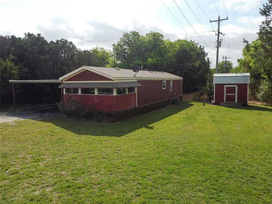 Perfect lake getaway for a weekender, retiree, or couple.  Very close to the lake – one access is a free park with a boat ramp called Cedar Creek Park and the other is the Old Fort Graham Park that has been abandon but you can still walk through it.  This one bedroom, one bath singlewide sits on two treed lots with one being a corner lot.  It has a storage shed and an attached carport.  The front porch was enclosed by the previous owner but could easily be turned back into a porch.  Perfect place to sit and watch the birds.  All appliances convey.  This one is priced to move!
