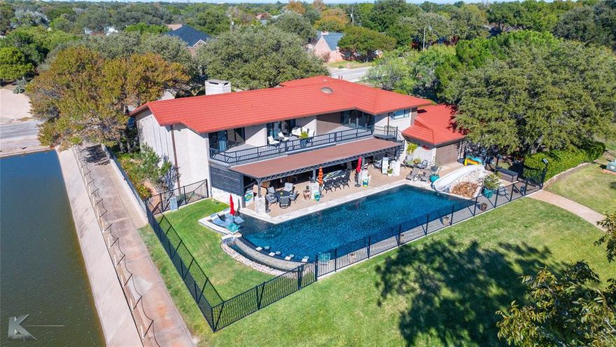 Stunning home on Fairway Oaks Country Club ACC South Course! This wonderful home has a beautiful view of the golf course and lake at the 18th tee box. Experience luxury in this breathtaking 5,500+ sq. ft. estate boasting 3 spacious bedrooms, 3 full bathrooms and 2 half bathrooms. There is ample space for both entertaining and comfort. Step inside to two modern living areas and two formal dining spaces. The eat-in kitchen is a chef’s dream, featuring high-end appliances, a large island and ample space perfect for hosting gatherings. The primary suite has an expansive balcony overlooking the beautiful lake on the golf course and the luxury heated pool. A spacious laundry room adds convenience and functionality, and the two-car garage has extra space for parking two golf carts from a back entrance right off the golf course. The outdoor kitchen and covered patio along with the custom swimming pool complete with water features and slide create an entertainment paradise. Large windows radiate light throughout this must-see home! Buyer and buyer's agent to verify square footage & schools.