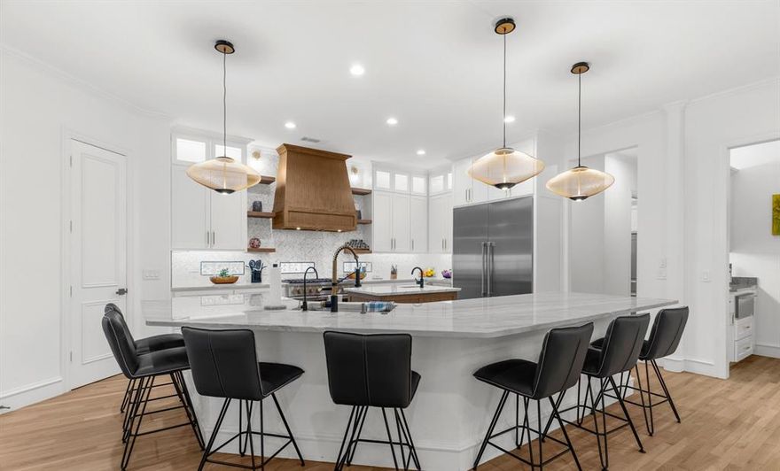 EXQUISITE REMODEL with high-end finish-outs and designer details. Dramatic light fixtures, a 15 foot kitchen island with quartzite, 60 inch built in subzero fridge, chef grade GE Monogram range and working pantry are just some of the features that make this single story 4 Bedroom ALL WITH ENSUITE baths so special. The double sided fireplace in office and living room overlooking pool and pond make for gracious living and working. Natural colored oak hardwoods flow from room to room. The primary suite has a luxurious bath and customized closet. No expense was spared in any of the renovations! Covered patio and pool and spa overlooking two of the 7 ponds in Wellington Point make for a lovely backdrop and another full bath makes for pool and guests a perfect design. Upstairs is only a game room and half bath. The circle drive and deep 4 car garage (1 with electric vehicle charging outlet) provide enough space for family and friends in this entertainer's dream home! This is an absolute MUST SEE!