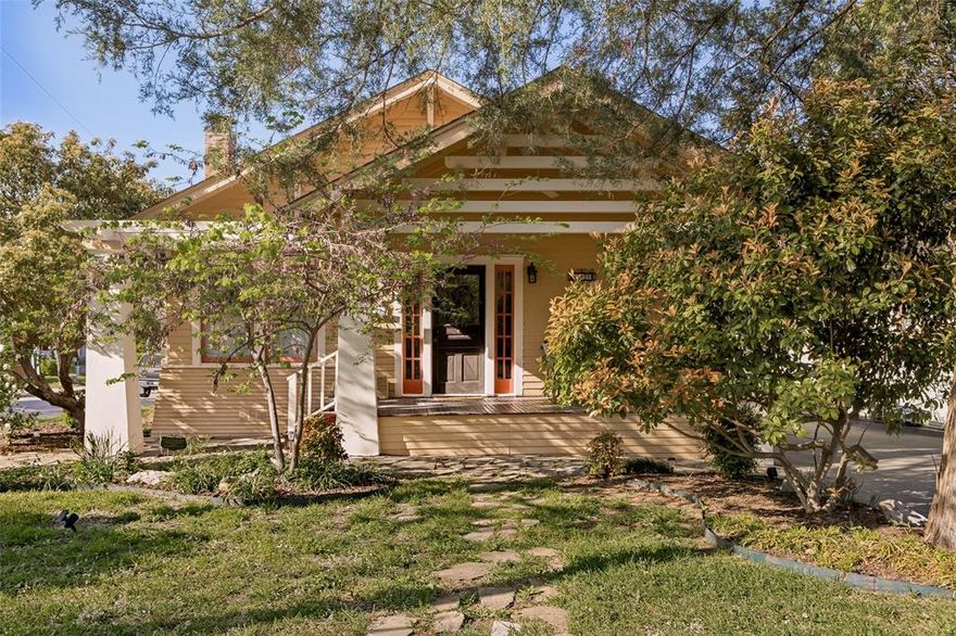 Welcome to this wonderfully charming 1930 Craftsman home in the highly sought-after McKinney Historic District. Just a scenic stroll, approximately three quarters of a mile, brings you to the vibrant downtown square.

Situated on a large corner lot, this property is surrounded by gorgeous mature trees, charming flagstone pathways, and inviting outdoor spaces. Whether you enjoy gardening, relaxing on one of the two porches, or simply birdwatching for a spell, this home offers a peaceful and picturesque setting.

Inside, you’ll find a true Craftsman bungalow with 9-foot ceilings and beautiful sight lines from the living room, anchored by the original gas fireplace, to the lush greenery visible from the kitchen. Much of the original hardwood flooring remains, complemented by classic details such as shiplap, wainscoting, wide baseboards, and crown molding.

This is an authentic 1930s Craftsman, originally built alongside its twin on the same street and known as a “twin oriental craftsman.” It is not a kit home. Original features include transom windows at the front entry, preserved interior doors, two pocket sliding doors, glazed windows, and plantation shutters.

Thoughtful updates include HVAC improvements, updated electrical outlets, a tankless water heater, and recent exterior painting and skirting.

The primary bedroom offers two closets, one quite spacious, with flexibility to relocate the washer and dryer and convert the current laundry room into a half or full bath.

The detached garage includes an attached storage room with potential to become guest quarters, a studio, or a creative workspace.

A rare opportunity to own a true historic gem full of character, charm, and potential in one of McKinney’s most beloved neighborhoods. Come experience it for yourself.