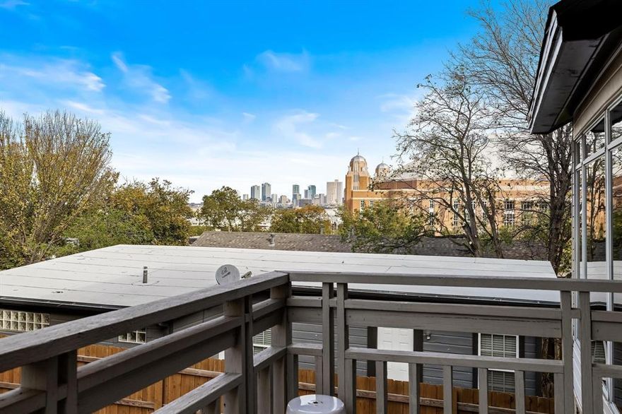 Welcome to this stunning 3-bedroom, 2.5-bath townhouse in Fort Worth’s Cultural District. Built in 1991, this contemporary home offers 1,773 sq. ft. across three levels with dramatic views of the downtown skyline, Dickies Arena, and nearby museums from walls of glass and multiple balconies. The flexible layout features soaring cathedral ceilings, a striking dual staircase, and a main living area with abundant natural light, a gas fireplace, and balcony access for al fresco dining. The kitchen includes a gas cooktop, built-in appliances, microwave, dishwasher, and ample cabinetry. Bedrooms are thoughtfully placed for privacy, with one on the main living level—perfect for a guest room, office, or flex space—and two upstairs, each with a full bath. With its contemporary design, skyline views, and walkable location near dining, shopping, and entertainment, this home offers the best of Fort Worth living.