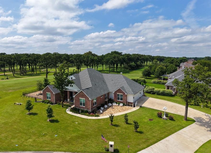 Stunning custom home on .72 acres surrounded by beautiful golf course views around the entire property. Located in Cedar Creek Country Club, a prestigious East Texas waterfront community less than an hour from Downtown Dallas. Quality and attention to detail shine from the moment you step onto the covered porch and open the custom wood doors. The open-concept living area features large picture windows, wood floors, vaulted shiplap ceilings with wood beams, and a gas fireplace. The kitchen is a cook’s dream with a walk-in pantry, GE built-in oven and microwave, oven range, warming drawer, and both farmhouse and prep sinks with touch faucets. Quartz countertops, a spacious island, and large dining area make it ideal for gatherings. Great storage throughout. Three en suite bedrooms plus an office-library with built-in shelves and sliding ladder. All baths include walk-in showers with waterfall glass doors and double vanities. The primary suite offers dual shower heads, a clawfoot tub, and a custom walk-in closet with built-ins and pull-down rods. The large utility room doubles as a hobby or craft space with ample cabinetry, counters, and a hidden pull-out sewing table. 9’ doors and 15’+ ceilings give the home an airy, comfortable feel. Upgrades include spray foam insulation in the house, attic, and garage, upgraded Pella windows, and tankless water heater. The home features two fireplaces—one inside and one outdoors. Enjoy the 671 sq ft screened porch with hot tub and outdoor kitchen featuring a built-in Coyote grill, sink, and fridge. Outside, relax by the outdoor gas fireplace, play on the 5-hole putting green, or gather on the large flagstone patio—each with sweeping golf course views. The 1,060 sq ft three-car garage includes golf cart parking and a temperature-controlled storage room, plus an in-ground storm shelter. Community amenities include tennis and pickleball courts, pool, and clubhouse dining. Golf and social memberships available.