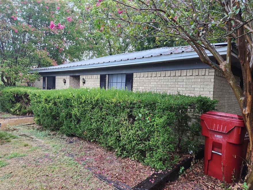 Great investment opportunity, brick house located downtown Quinlan and close to schools, shopping and Lake Tawakoni. The home has two bedrooms, one bathroom. Eat In kitchen has updated stainless steel appliances. Livingroom offers nice built in cabinets with bookcase, drawers, plugs. Roof updated to metal.  Large back yard with pecan trees which includes the city alley and storage building on slab foundation. Foundation will need repairs and central heat and air, have bids to share. All information is approximate, buyer and buyers agent to verify all information