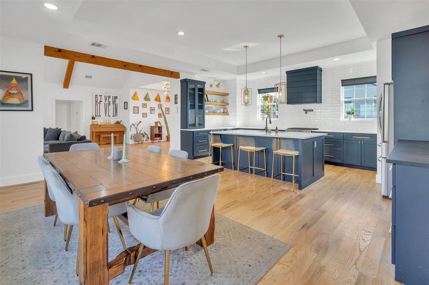 This stunning modern farmhouse offers the perfect blend of timeless design and modern functionality in the heart of West Dallas. Renovated in 2021, the home showcases exceptional attention to detail. Featuring vaulted ceilings with exposed wood beams and abundant natural light, the open-concept layout is ideal for everyday living and entertaining. The kitchen features quartz countertops, a large island, six-burner range, walk-in pantry, custom cabinetry with pullout drawers, and a built-in buffet with wine fridge. The private primary suite offers a spa-inspired bath with dual vanities, a freestanding soaking tub with spacious shower, and a large walk-in closet. Situated on a generous quarter-acre corner lot with a charming front porch and oversized two-car garage, this home is just minutes from Sylvan Thirty, Trinity Groves, the vibrant Bishop Arts District, and downtown Dallas, in one of the city’s fastest-growing neighborhoods. Updates include: HVAC, tankless water heater, attic insulation, foundation vents, custom window shades, side gate, dishwasher, and wine fridge (2021); parking pad (2022); range (2023); French drain and updated primary bath tilework (2025). Ask to see the 3D tour!