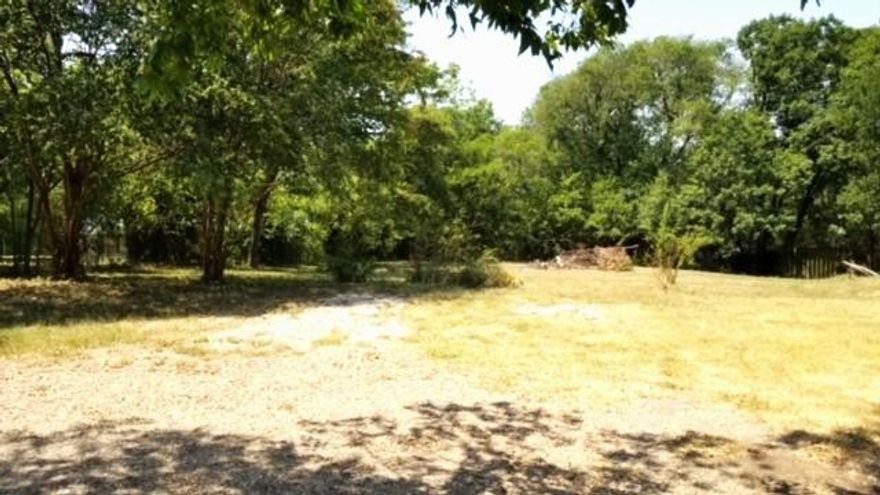 3.658 Acres with tons of possibilities. One of the few lots left where you can have a mobile home and no HOA fees. This property is heavily treed with several mature trees, a pond, dry bed seasonal creek, and a shallow well near the pond. There are several outbuildings including an approx. 700 sq ft shop with concrete floor, electrical, sliding door and a walk thru door, a smaller workshop with concrete, electrical and 2 window ac units along with a greenhouse and an underground storm shelter. There is also an approx. 1450 sq ft 3 bedrooms, 2 bath singlewide mobile home on the property that will be included with a bill of sale. The home has been lived in until a few months ago but is a fixer upper. The property is fenced and has 3 drive thru gates and 3 walk through gates along with concrete walkways and a concrete patio for family gatherings. There are 2 water meters on the property and no known restrictions. Bring your family and your imagination and make it your own!