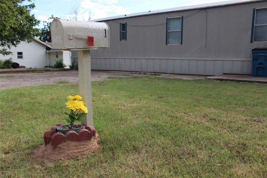 Charming and move-in ready, this 3-bedroom, 2-bath manufactured home at 601 S Crockett St in Henrietta, TX offers 1,178 sq ft of comfortable living space with central HVAC, an open layout, and abundant natural light. Built in 1999 and well-maintained, it’s ideal for first-time buyers, downsizers, or investors seeking a low-maintenance property. The spacious backyard features two large 20' x 12' steel sheds, perfect for storage, workshop space, or hobby use. Located just 25 minutes from Wichita Falls, this home blends small-town peace with quick access to city conveniences, schools, and major highways—making it a smart and versatile choice in a welcoming community.