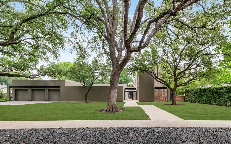 This architectural gem designed by Lionel Morrison is located in sought-after Devonshire Estates. This 5,100 sq ft residence offers timeless design, exceptional privacy, and seamless indoor-outdoor living. Floor-to-ceiling windows with automatic screens and pocketing glass doors frame serene views of a courtyard with pool, magnolia hedges, and mature live oaks.Built for both entertaining and everyday living, the main house features an open-concept living and dining area with a gas fireplace, concrete floors, and custom built-ins throughout. The chef’s kitchen includes a Sub-Zero wine chiller, Wolf range, two dishwashers, stainless steel surfaces, and marble accents. A powder bath and spacious utility room are conveniently located near the main-level primary suite, which offers pool access, dual closets, a spa-inspired marble bath with soaking tub, double vanities, and abundant storage.
Upstairs, two bedrooms feature private baths and a shared balcony with views of the pool and trees. The detached guest house includes a full bath, office nook, kitchenette with refrigerator, microwave, sink, ice maker, and generous storage—ideal for guests or long-term stays. Additional highlights include a three-car garage with workshop, whole-home system, and a peaceful, green setting in one of Dallas’ most architecturally notable neighborhoods.