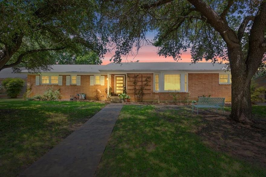 Welcome to this beautifully maintained home nestled on a quiet, tree-lined street in the heart of Waco! Inside, the home honors its 1959 character while feeling quietly refreshed with thoughtful updates. Natural light fills the main living space, where white walls, designer lighting, & wood beam accents create a warm, inviting atmosphere. Updated solid maple flooring runs seamlessly through the living areas, kitchen, & bedrooms, bringing a sense of cohesion throughout. A bay window frames views of the front yard’s established oak trees, casting soft natural light into the room, while the dining area offers an easy, comfortable place to gather. The kitchen feels both inviting & easy to live in, with white cabinetry, butcher block countertops, & a clean, simple backsplash. High-end double ovens & a gas cooktop make it just as functional as it is welcoming, while a custom cast-iron sink sits beneath a window looking out to the backyard. New tile flooring ties the space together with a fresh, finished feel. The layout offers a comfortable sense of flexibility, with three spacious bedrooms & a fourth room that easily adapts—whether as a home office, guest space, or a place to create. Out back, a patio sets the stage for easy outdoor dining, with plenty of space to relax, garden, or entertain. The yard is beautifully maintained, offering a clean, established canvas that can easily be shaped to fit your own vision. A large garage with additional storage, a storage shed, & a sprinkler system in both the front & backyard add everyday ease & practicality. Located just minutes from Waco’s shopping, dining, & entertainment—and about 15 minutes from Magnolia Market at the Silos—this home sits in a quiet, tree-lined, family-oriented neighborhood known for its sense of ease & community. With numerous grocery stores nearby & proximity to Cameron Park & other public parks for kids, it offers a setting that feels easy to settle into & a community to nestle into.