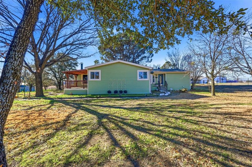 PRICED BELOW RECENT APPRAISED VALUE!  Welcome to this beautiful home on over 6 acres offering space, character, and peaceful views—all in a prime location. Thoughtfully refreshed and move-in ready, this property blends modern finishes with warm, inviting living areas designed for both comfort and entertaining. Step inside to a spacious living room filled with natural light, crown molding, and fresh neutral tones. The open layout flows effortlessly into the heart of the home—a stunning kitchen featuring granite countertops, an oversized island, stainless steel appliances, custom cabinetry, and rich wood tone flooring. As an added value, the refrigerator and washer & dryer will convey with the house. The adjacent breakfast nook is framed by large windows, creating the perfect spot to enjoy morning coffee while overlooking the backyard. A separate family room offers a cozy retreat highlighted by a beautiful stone fireplace, wood beam accents, and direct access to the covered back deck—ideal for gatherings or quiet evenings outdoors. The primary suite is generously sized and thoughtfully designed, complete with a walk-in closet and an updated ensuite bath showcasing a freestanding soaking tub, modern vanity, and stylish finishes. Secondary bedrooms are well-proportioned and share updated bath space, offering flexibility for family, guests, or a home office. Step outside to the covered deck and expansive yard beyond, including your own pond stocked with bass and catfish—perfect for relaxing, entertaining, or simply enjoying the open views. With multiple living areas and a layout that provides both privacy and functionality, this home offers the ideal balance of comfort and style in a desirable setting.