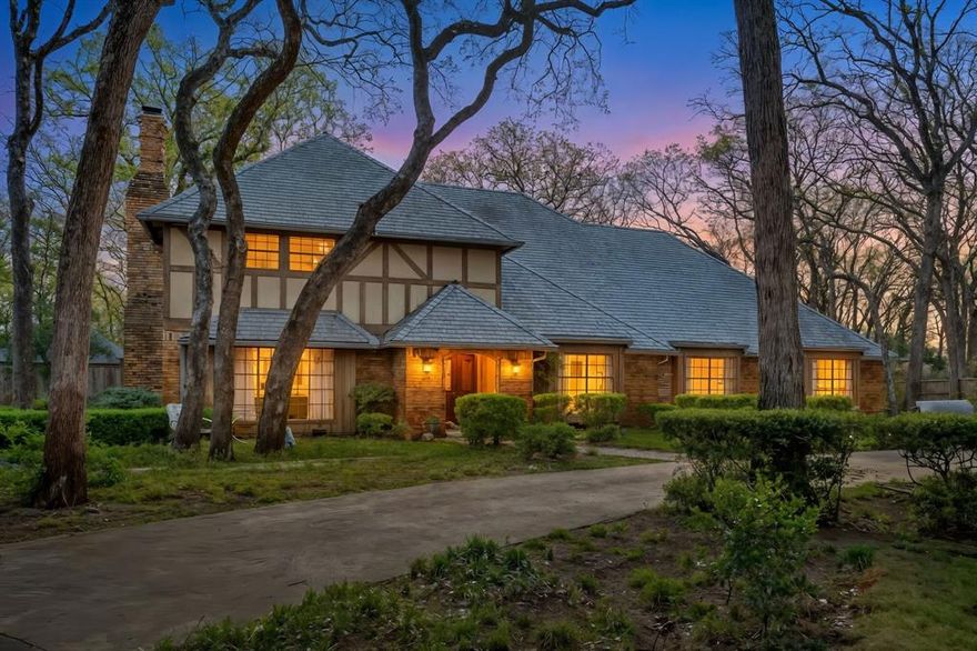 From the moment you step inside, the stained wooden staircase welcomes you with a warm embrace, complete with detailed banister work that climbs the wall leading you to the two primary bedrooms upstairs. To one side of the entrance, a warm den anchors the space with a wall to wall raised hearth and wood burning fireplace, then flows into a cute library with built in bookcases and a window seat that practically begs for coffee, thunderstorms, and neglected to do lists. Beyond that you’ll find a sunroom or office wrapped in bench seating, exposed brick pillars, sconces, bookshelves, and even a thoughtfully placed pot filler down low for the family pet. On the other side of the staircase, that has a hidden door to under the stairs storage in the woodwork, you'll find the perfect setting for an office, music room, or quiet sitting space that leads into a formal dining room with pocket doors to a kitchen that is truly worthy of the phrase ENTERTAINER'S DREAM. Multiple mini fridges, double ovens, double dishwashers, warming drawer, ice maker, trash compactor, pantry, spice pull out racks, two pull out appliance stations, bar seating, breakfast bar, multiple sinks, and TWO ADDITIONAL pot fillers. Tucked away, the game room brings all the fun and history with coffered ceilings, a classic ice cream and soda fountain, and a piece of the famous Worth Theatre on display overhead! Every bedroom has its own ensuite bath, while the guest half bath adds character with an engraved copper sink and vintage toilet. The primary suite comes with a flexible bonus room and private access to a balcony overlooking the backyard that feels like a retreat, with a two tiered waterfall hot tub, a gorgeous pool with a rock diving board, and flagstone paths that lead to features such as a fire pit, multiple seating areas, two separate dog runs, boat or small RV parking pad, a storage shed, and a workshop with electric and water! Text the Listing Agent for a full Features and Updates list!
