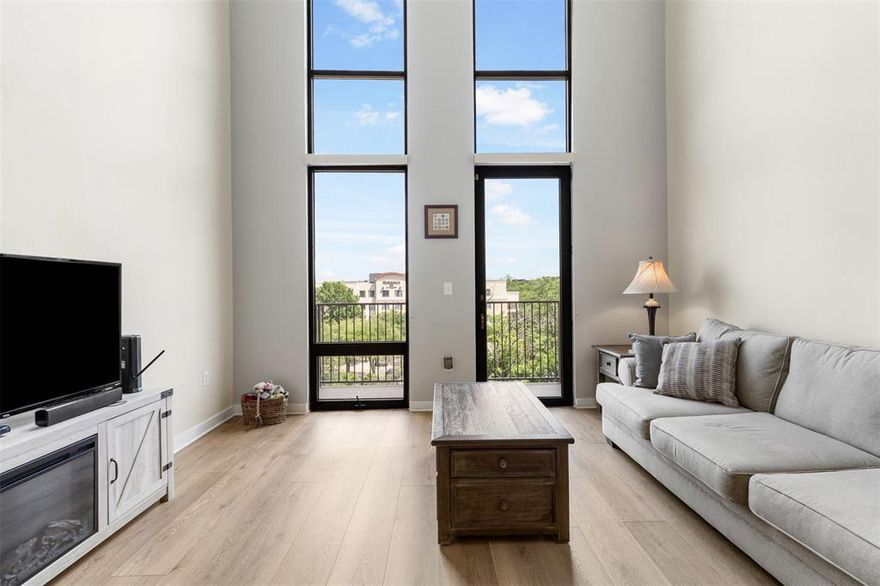 Experience modern urban living at its finest in this stunning two-story loft-style condo located in the heart of Fort Worth’s vibrant West 7th district. Situated on the top 2 floors of the ArtHouse at So7, Unit 3407 offers 1,730 square feet of contemporary design, featuring soaring 20-foot floor-to-ceiling windows that flood the space with natural light and provide captivating views of the downtown skyline. The open-concept main level seamlessly integrates the kitchen, living, and dining areas, creating an ideal space for entertaining. The kitchen is equipped with modern appliances, including an electric cooktop, oven, microwave, refrigerator, and dishwasher, complemented by sleek finishes. A guest bedroom with an en-suite full bath and a convenient half bath complete the main floor. Ascend to the upper level to discover a spacious primary suite featuring a private entrance to the fifth floor, a luxurious bathroom with a deep garden tub, separate shower, and a custom-built walk-in closet. Recent updates new LVT flooring and 2 new HVAC units with new thermostats. Enjoy outdoor living on the private balcony with panoramic downtown views. Additional amenities include a deeded parking space in the garage and 1 unreserved space, access to a community pool, a dog area. Located just minutes from Downtown Fort Worth, Trinity Park, and TCU, UNTHSC, this condo offers unparalleled access to shopping, dining, and cultural attractions. Don’t miss the opportunity to own this exceptional property in one of Fort Worth’s most sought-after neighborhoods!