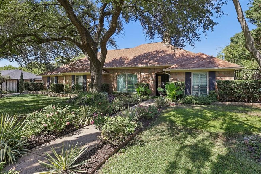 THIS IS A GREAT HOUSE located in one of the hottest areas of Dallas, and in a dynamic economic powerhouse area in the private school corridor, a beautifully maintained single-story home on a large lot with magnificent mature trees, where many happy memories were made. This residence features four bedrooms (or three bedrooms and a den), three bathrooms, three living areas, and two dining areas, blending timeless style with modern comfort. Features include gleaming wood floors, abundant natural light, and serene views from nearly every room. The renovated kitchen features a breakfast bar, a 6-burner gas cooktop, and a stainless-steel refrigerator. Adjacent breakfast nook with built-ins overlooks the sparkling pool. Enjoy multiple flexible living spaces, including a totally private, split red-painted guest room or den; an atrium that connects you to nature; and a covered patio for year-round outdoor living. The heated pool, powered by solar panels, invites swimming year-round. The formal living area features a vaulted ceiling, fireplace, and hidden wet bar. The primary suite features his-and-hers bathrooms, dual walk-in closets, a renovated bathroom with a walk-in shower, a spa tub, and a bidet toilette. Additional highlights: detached 26' x 20' 2-car garage with side entry and electric gate, large area for RV parking, French drains, cedar-lined closets throughout, roof replaced in 2021, and more. Seller offers a $5,000 allowance for the buyer’s choice of fixtures. This exceptional home combines elegance, comfort, and convenience in one of Dallas' most desirable areas!