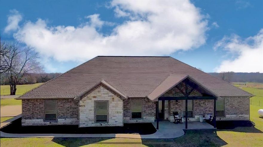 This elegant estate sits on 99 acres of Texas countryside with 0.5 mile of Rowdy Creek frontage. It features a main home with 4 bedrooms, 4.5 bathrooms, open-concept kitchen, and luxurious living room. Built for durability and energy efficiency, it boasts high ceilings, radiant barrier roof decking, and more. Additional amenities include a den-office, art room or office, screened-in porch with hot tub, and a second home with 3 bedrooms. A separate guest suite, RV garage, insulated shop, and custom hunting blind enhance the property's versatility. Surrounded by green pastures, hay meadows, and wildlife, it offers opportunities for recreation and income generation, including short-term rentals and events. This estate provides an unforgettable Texas retreat or investment opportunity.